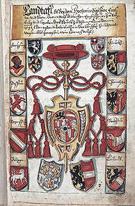 Landtafel des Erzstifts Salzburg, Anfang 17. Jahrhundert. Die Landtafel beginnt mit dem vermehrten Wappen des Erzbischofs Wolf Dietrich von Raitenau (reg. 1587-1612) und dem Landeswappen im Schild, bekrönt von Legatenkreuz und Hut mit 12 Fiocchi, begleitet oben mit den Wappen der Inhaber der vier Erbämter (Nußdorf, Thurn, Thanhausen, Khuen) und unten links vom Phantasiewappen – drei Lilien – für den hl. Rupert und rechts vom Landeswappen. Die beiden Randleisten werden von den Wappen der acht Suffragan-Bistümer gebildet (Freising, Passau, Regensburg, Brixen, Gurk, Chiemsee, Seckau, Lavant). Dann folgen die acht Angehörigen des Prälatenstandes, nochmals die vier Erbämter (für den Herrenstand), weiters 63 "Landleute" für den Ritterstand, acht Städte und 22 Märkte. In Fortführung der mittelalterlichen Tradition wurden alle Abteien und Propsteien geladen. Von den genannten 50 geistlichen Institutionen ist der Großteil wohl in kirchlichem Zusammenhang mit Salzburg zu sehen, hätte aber weder einen Anspruch zur Teilnahme am Salzburger Landtag gehabt noch das Recht, weil sie längst zu anderen Ländern gehörten. Die Aufzählung ist ein Sinnbild für den rund 300-jährigen Versuch der Salzburger Erzbischöfe, einen Passstaat mit Alpenübergang zu schaffen, wie es in Tirol geschehen war, und kann als Symbol für den Herrschaftsanspruch der Salzburger Führungsschicht um 1600 gelten. Abgebildet: "Die acht Geistlichen": Chiemsee, Dompropst, Domdechant, St. Peter, Berchtesgaden, [Michael-]Beuern, Höglwörth, Nonnberg. (Landesarchiv Troppau/Zemský Archiv v Opavě, Handschriftensammlung 1007)